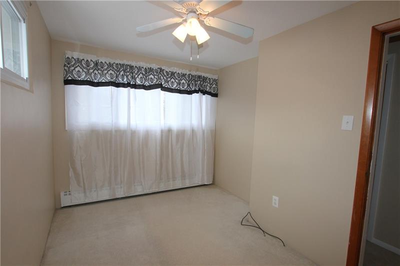 164 Oak Ridge Drive Butler, PA 16002 - Photo 18 of 25 This is Bedroom #3 at 14"x8" with a nice closet and a ceiling light fan and neutral tones.