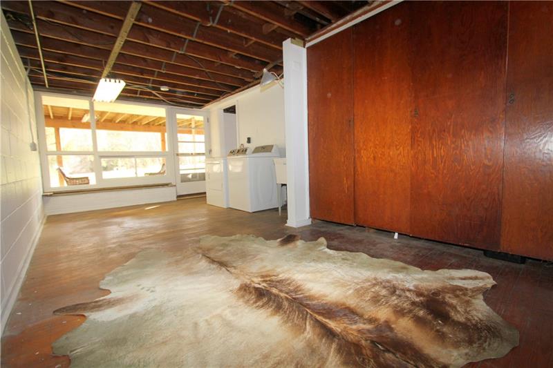 164 Oak Ridge Drive Butler, PA 16002 - Photo 21 of 25 This has long been a 21'x11' Game Room with a giant Tv and board games. The original hardwood floors could be sanded to perfection! The four solid wooden doors open to a large storage closet. I love that this room walks out to the giant, level back yard and a concrete patio.