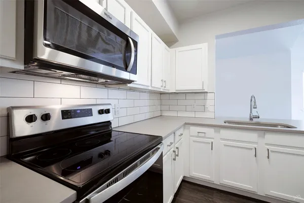 a kitchen with appliances and cabinets
