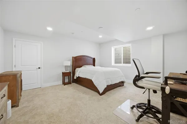 a bedroom with bed and a chandelier