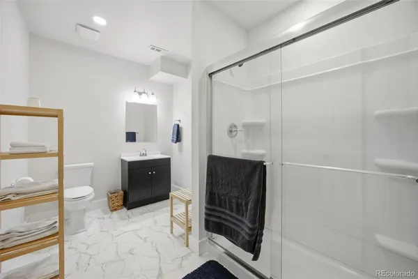 a spacious bathroom with a mirror and a shower