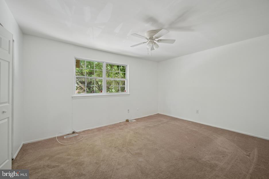 449 West School House Lane Philadelphia, PA 19144 - Photo 12 of 13 an empty room with a window and a fan