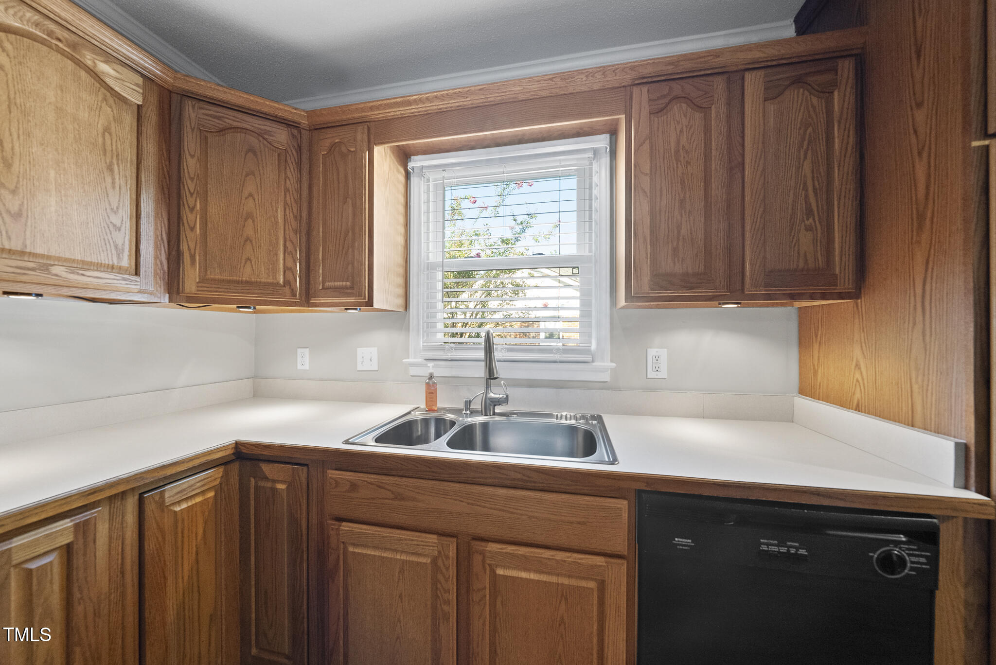 4500 Castlebar Drive Raleigh, NC 27604 - Photo 18 of 36 a kitchen with a sink cabinets and window