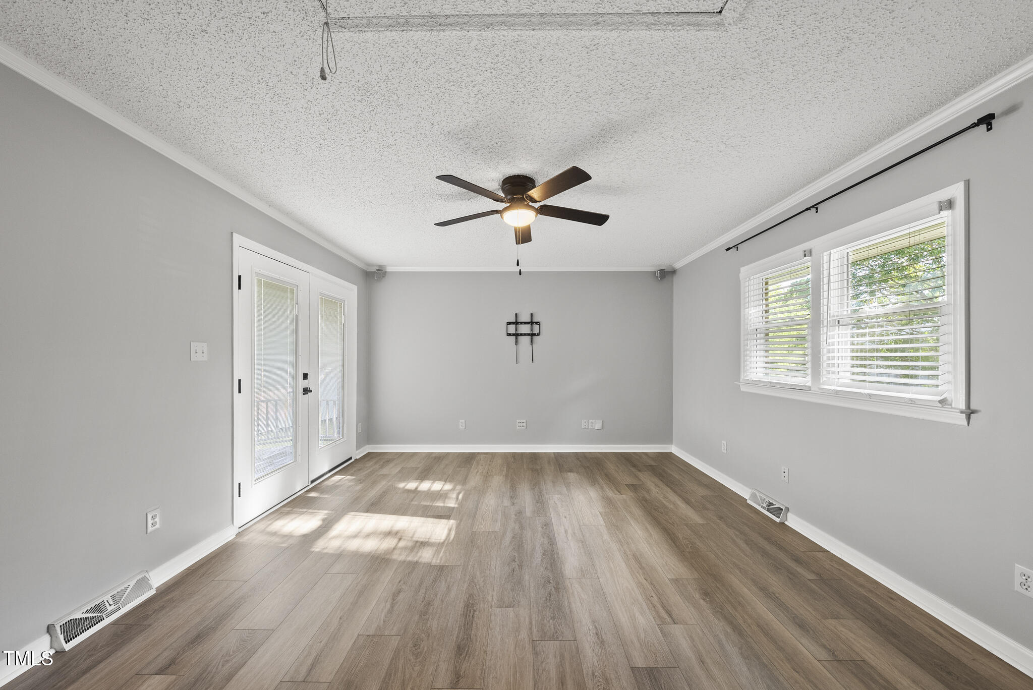 4500 Castlebar Drive Raleigh, NC 27604 - Photo 22 of 36 a view of empty room with wooden floor and fan