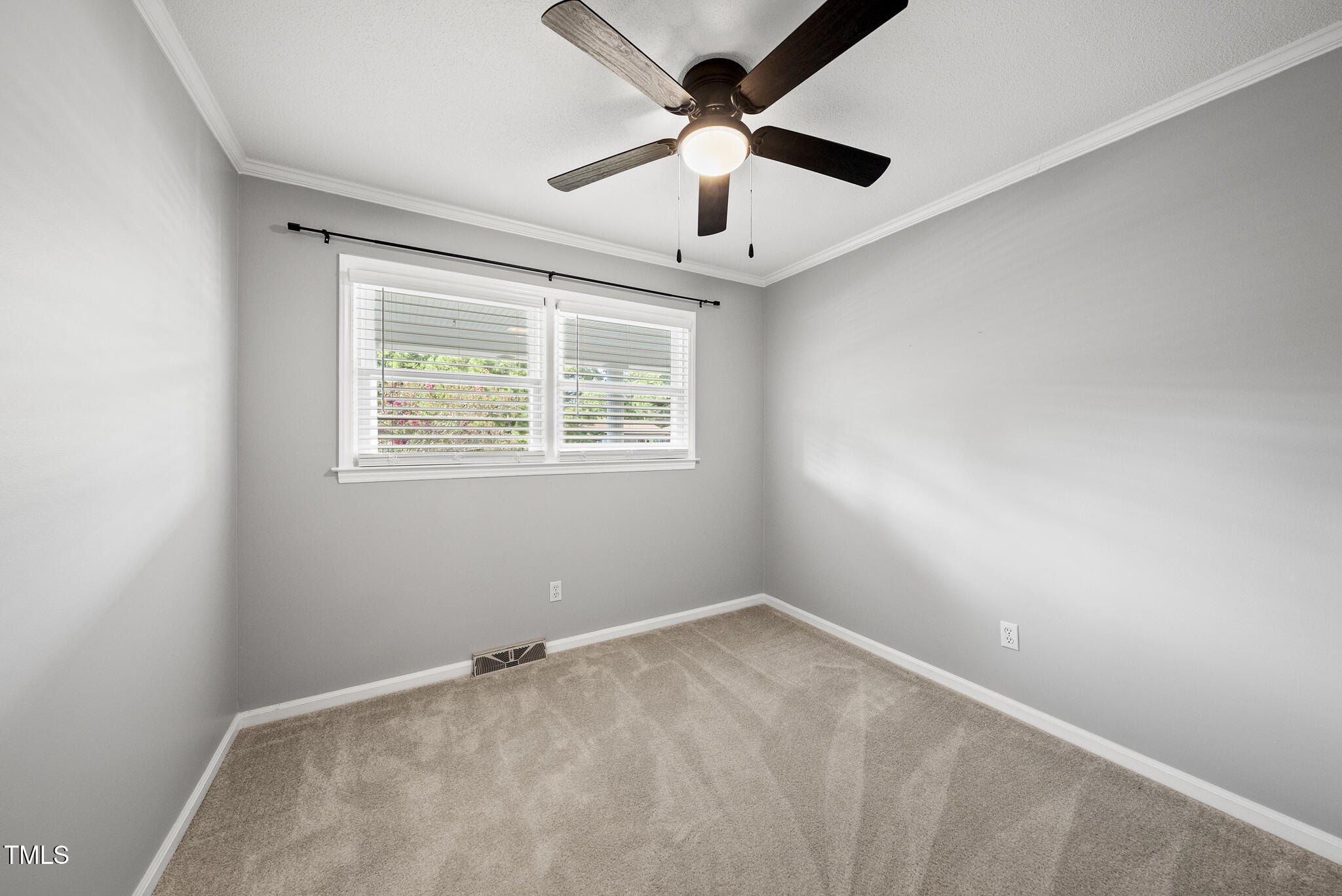 4500 Castlebar Drive Raleigh, NC 27604 - Photo 33 of 36 an empty room with a window and a fan