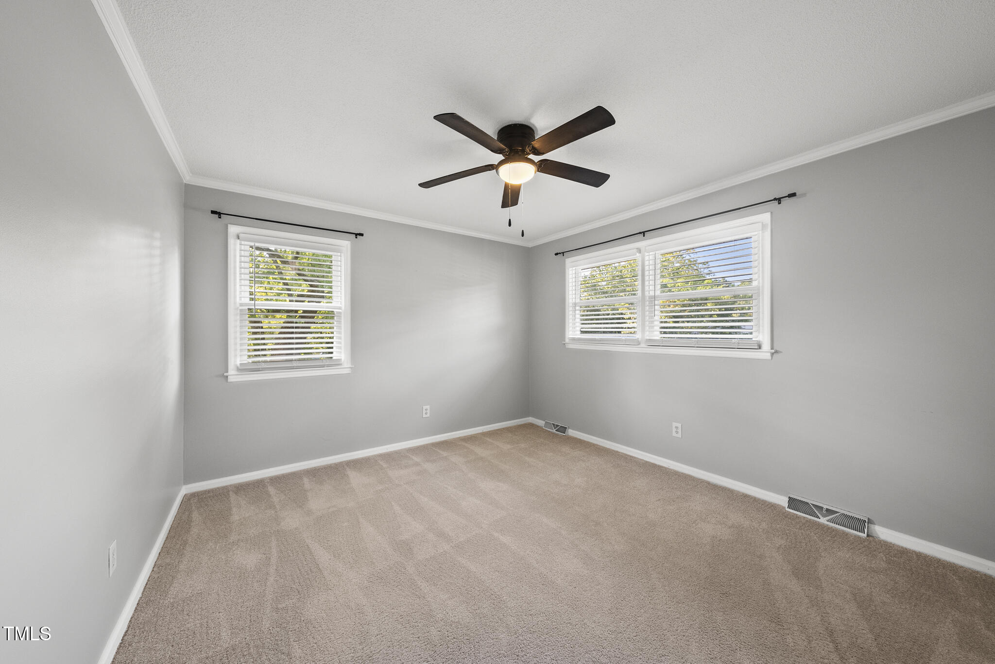4500 Castlebar Drive Raleigh, NC 27604 - Photo 35 of 36 a view of a bedroom with a ceiling fan and a window
