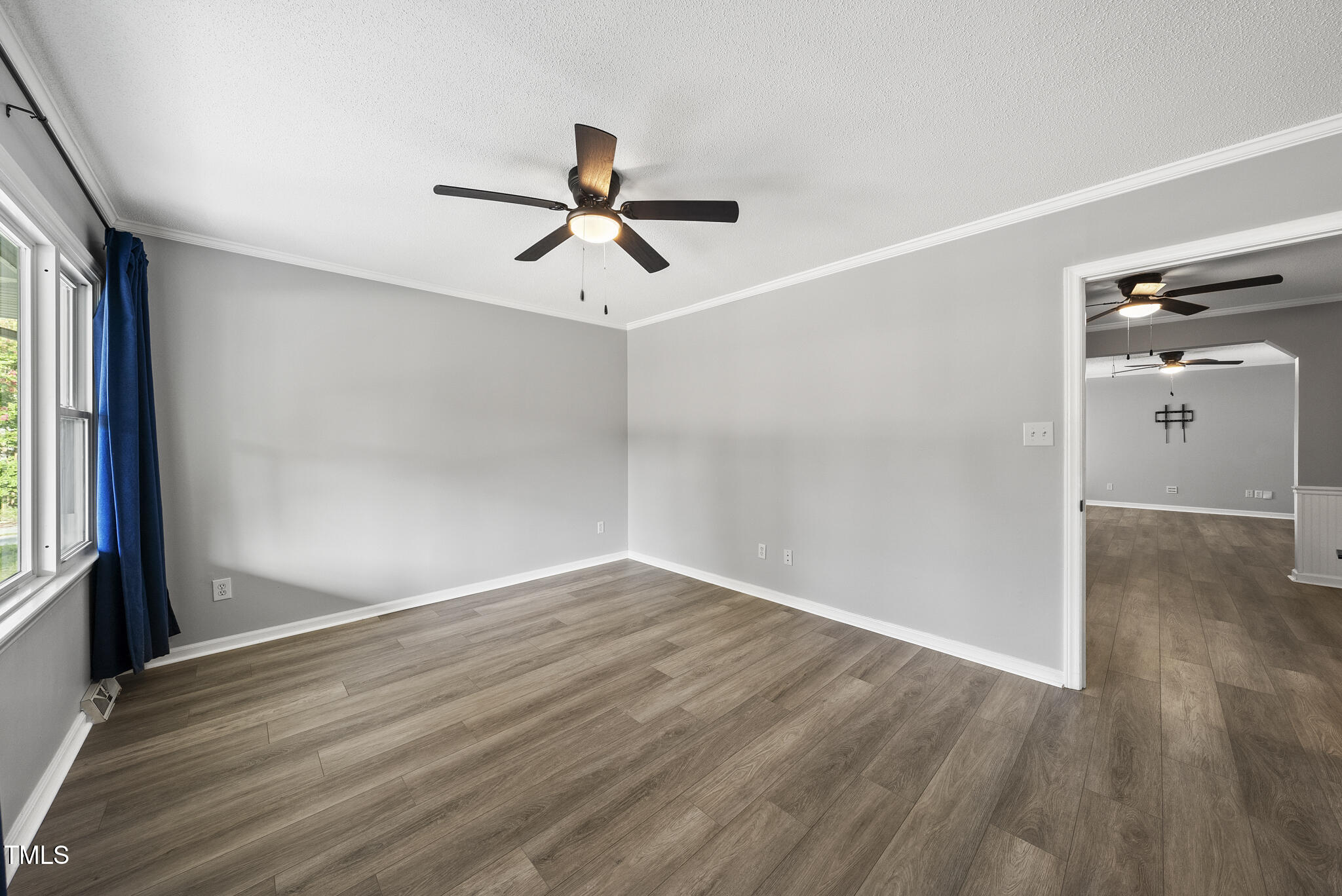 4500 Castlebar Drive Raleigh, NC 27604 - Photo 7 of 36 a view of empty room with wooden floor and fan