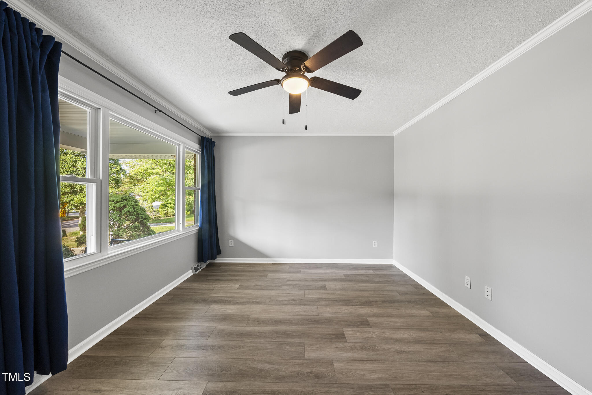 4500 Castlebar Drive Raleigh, NC 27604 - Photo 8 of 36 a view of empty room with wooden floor and fan