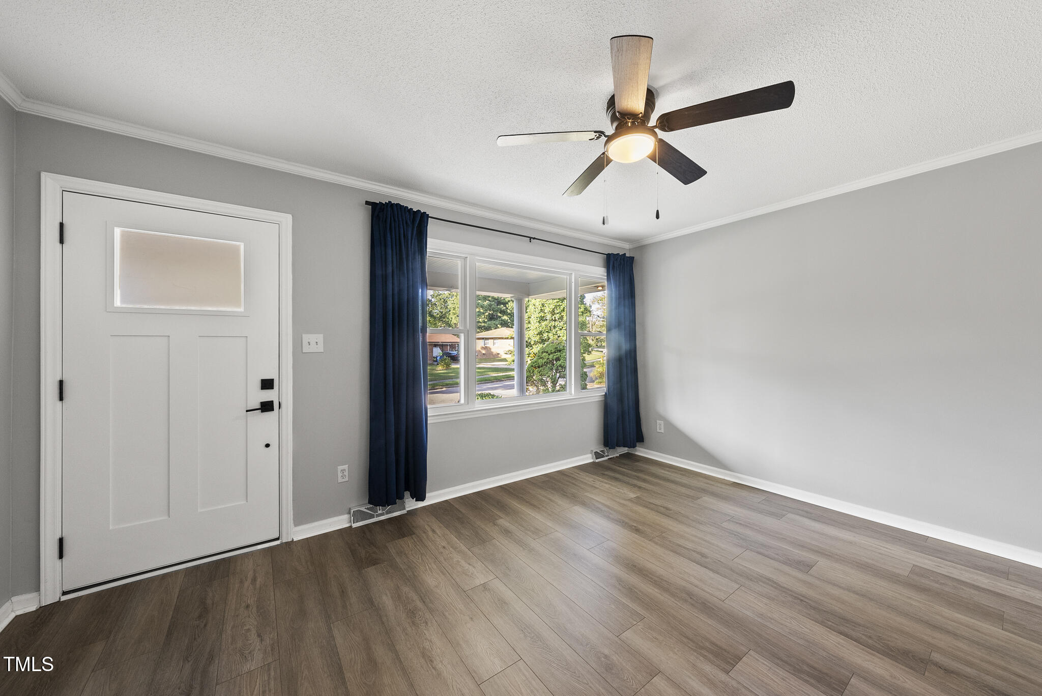 4500 Castlebar Drive Raleigh, NC 27604 - Photo 9 of 36 a view of an empty room with wooden floor and a window