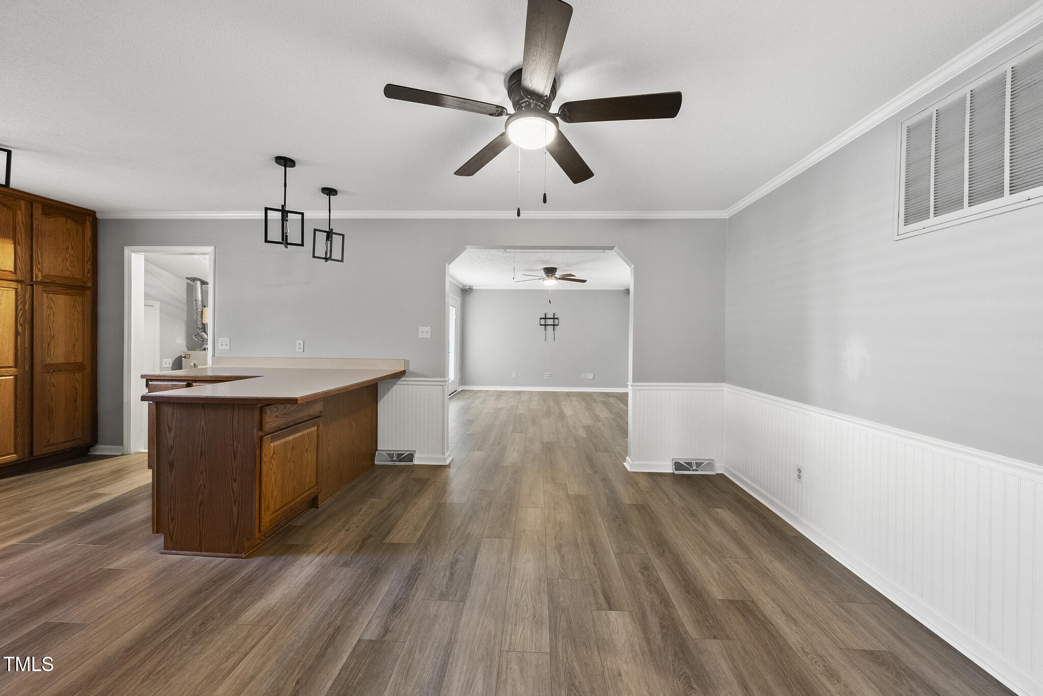 4500 Castlebar Drive Raleigh, NC 27604 - Photo 10 of 36 a large room with wooden floor and ceiling fan