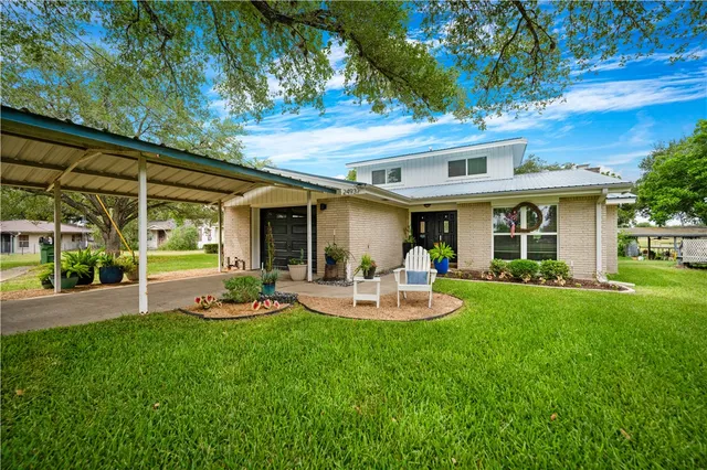 a view of a house with backyard and sitting area