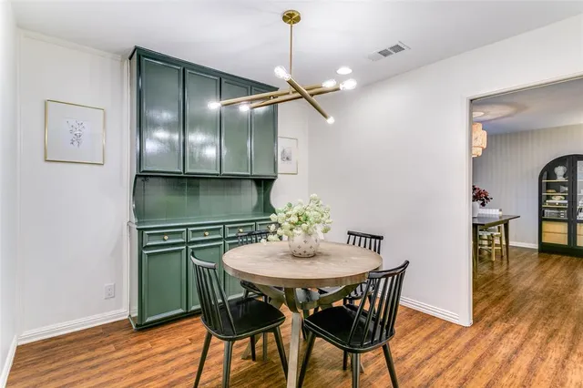 a kitchen with a table and chairs