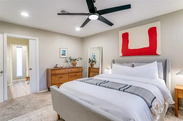 a bedroom with a bed and a dresser