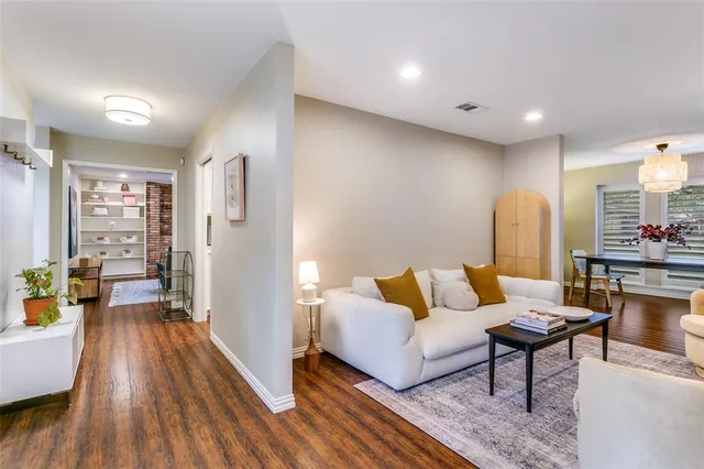 a living room with furniture and a wooden floor