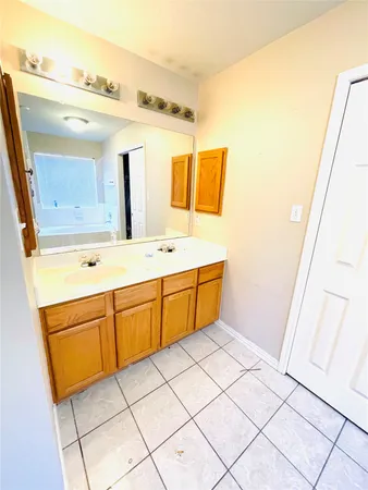 a bathroom with a sink vanity and mirror