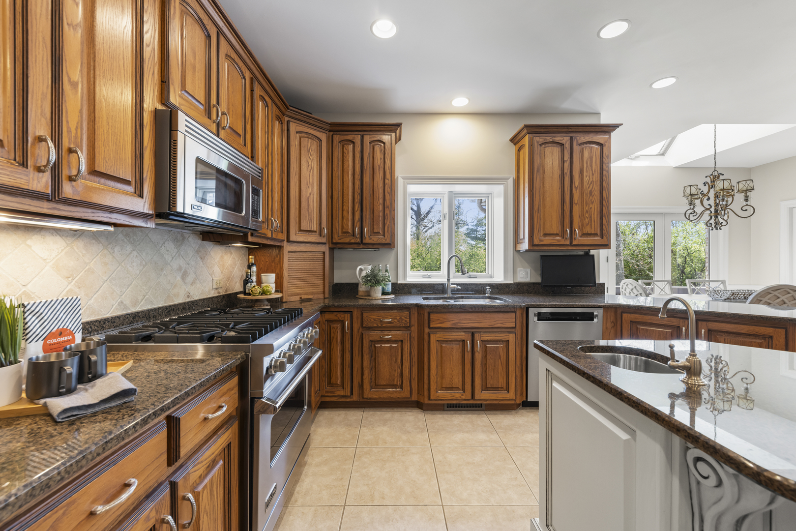 1S151 Winfield Road Wheaton, IL 60189 - Photo 22 of 73 a kitchen with stainless steel appliances granite countertop a sink stove and cabinets
