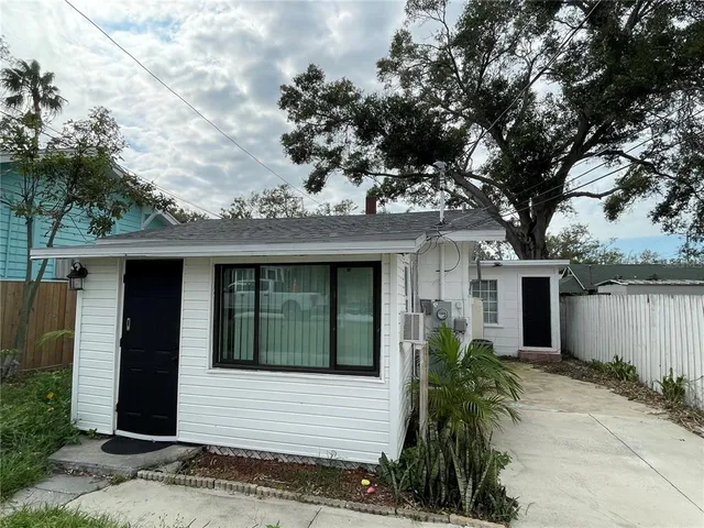 front view of a house with a tree