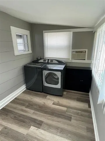 a living room with stainless steel appliances granite countertop a stove and a microwave