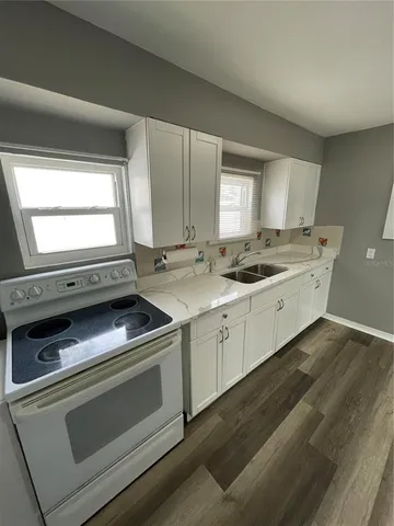 a kitchen with a stove and a sink