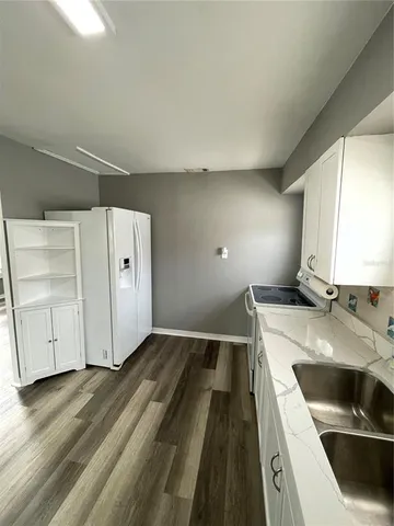 a bathroom with a double vanity sink and mirror