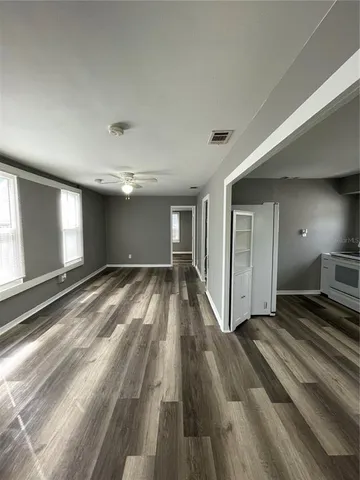 a view of a living room with wooden floor