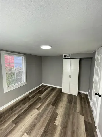 a view of an empty room and wooden floor