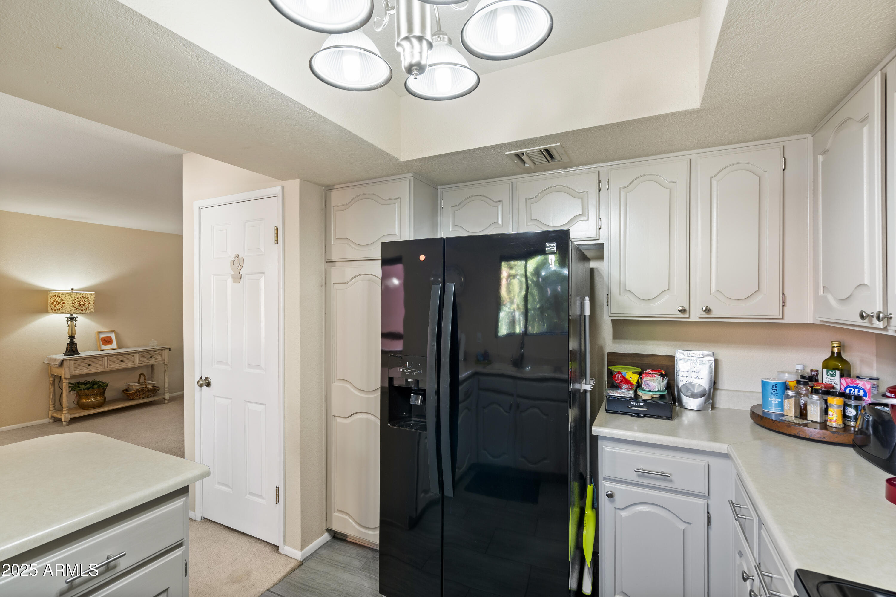 4303 East Cactus Road, Unit 222 Phoenix, AZ 85032 - Photo 13 of 38 a kitchen with a refrigerator a stove and cabinets