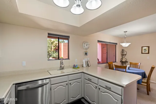a kitchen with a refrigerator a stove and cabinets