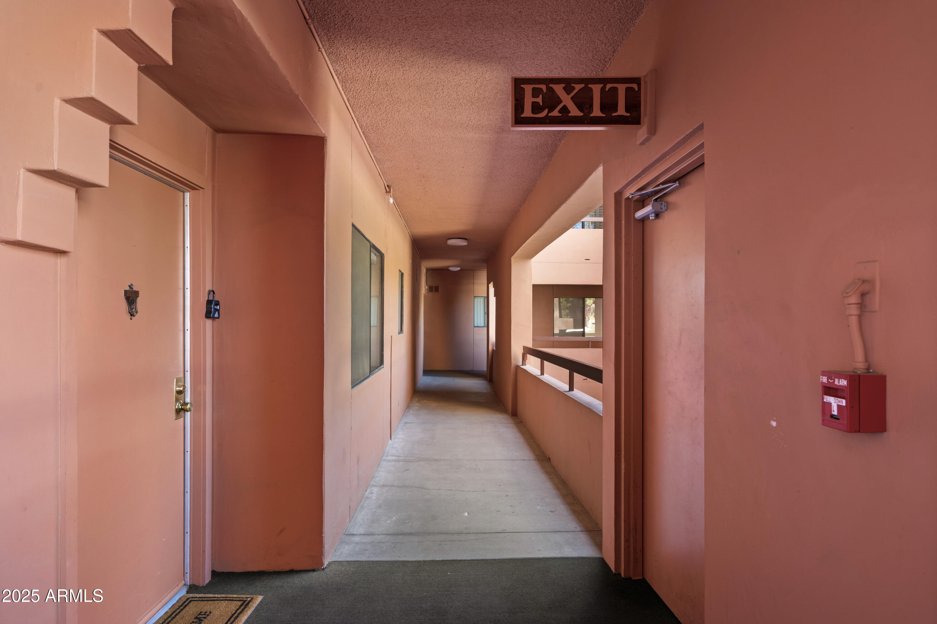 4303 East Cactus Road, Unit 222 Phoenix, AZ 85032 - Photo 21 of 38 a view of a hallway to rooms and stairs
