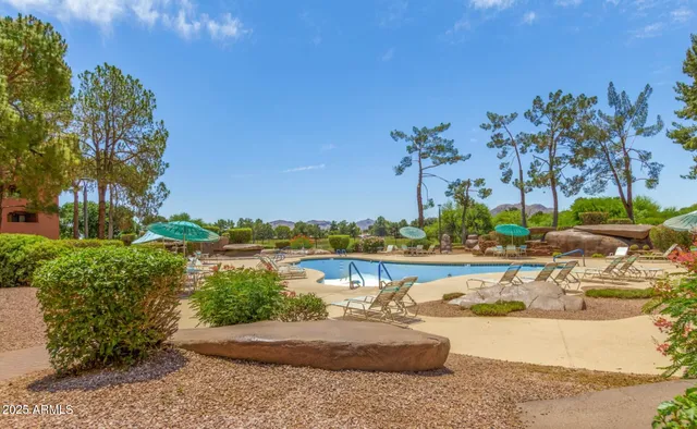 a view of a hallway to rooms and stairs