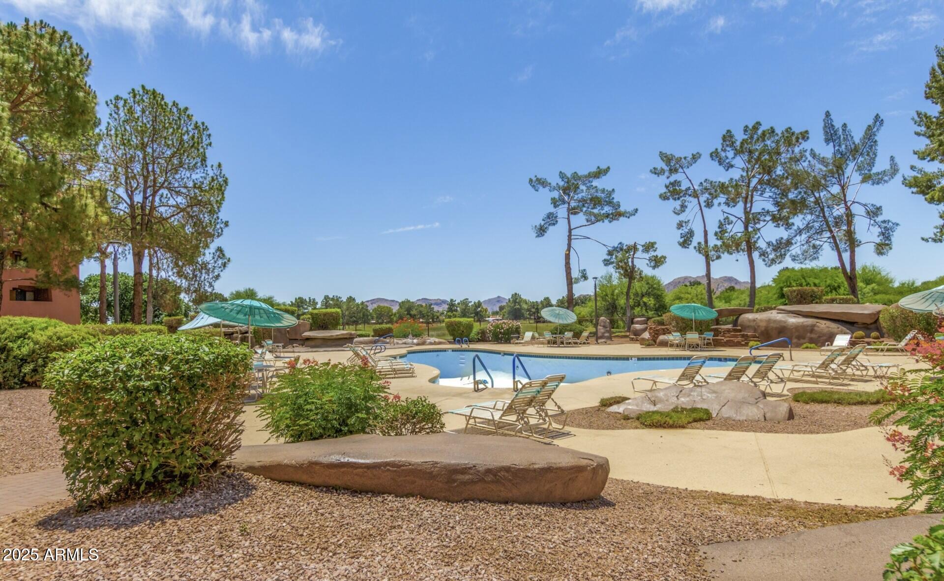 4303 East Cactus Road, Unit 222 Phoenix, AZ 85032 - Photo 22 of 38 a view of a lake with a table and chairs