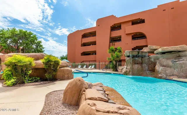 a view of a lake with a table and chairs