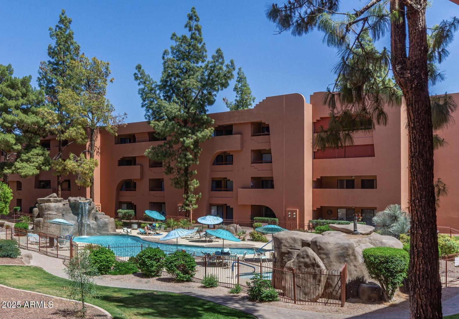 4303 East Cactus Road, Unit 222 Phoenix, AZ 85032 - Photo 24 of 38 front view of house with a yard and large trees