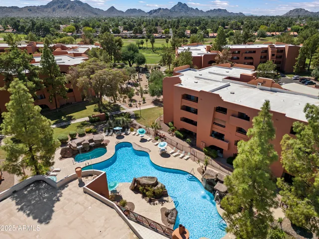 front view of house with a yard and large trees