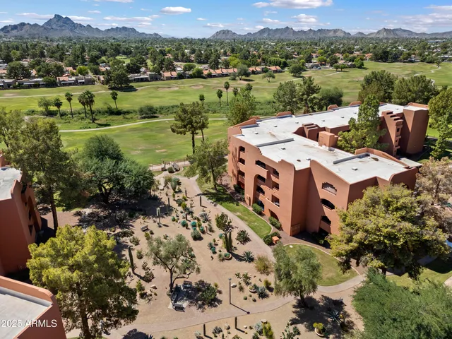 an aerial view of a house with yard kitchen and mountain view