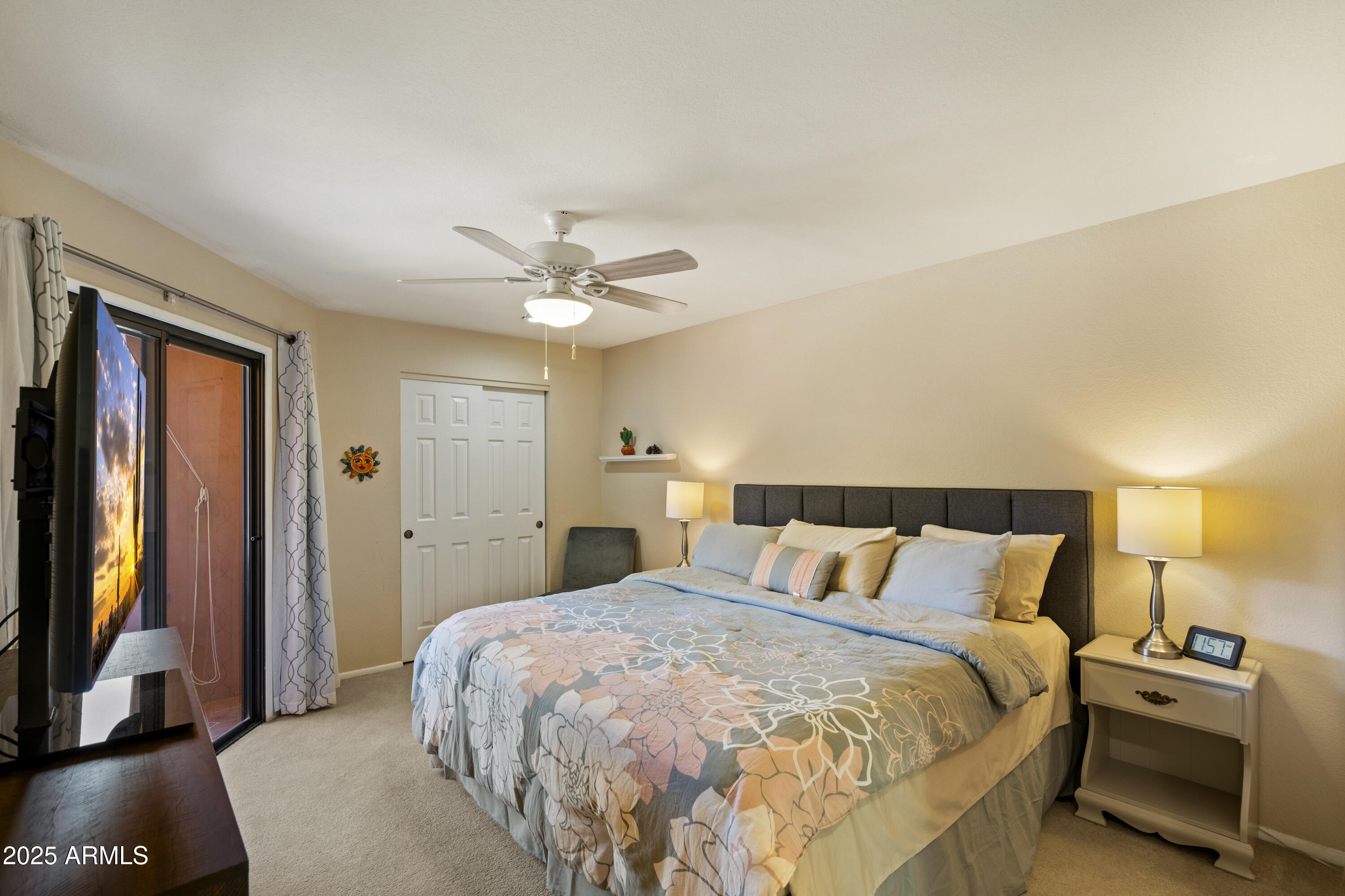 4303 East Cactus Road, Unit 222 Phoenix, AZ 85032 - Photo 2 of 38 a bedroom with a bed and a flat tv screen on dresser