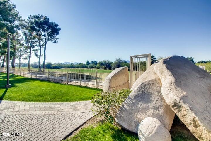 4303 East Cactus Road, Unit 222 Phoenix, AZ 85032 - Photo 31 of 38 a view of a house with a yard and a garden