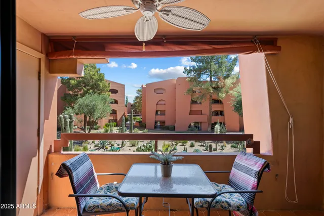 a bedroom with a bed and a flat tv screen on dresser