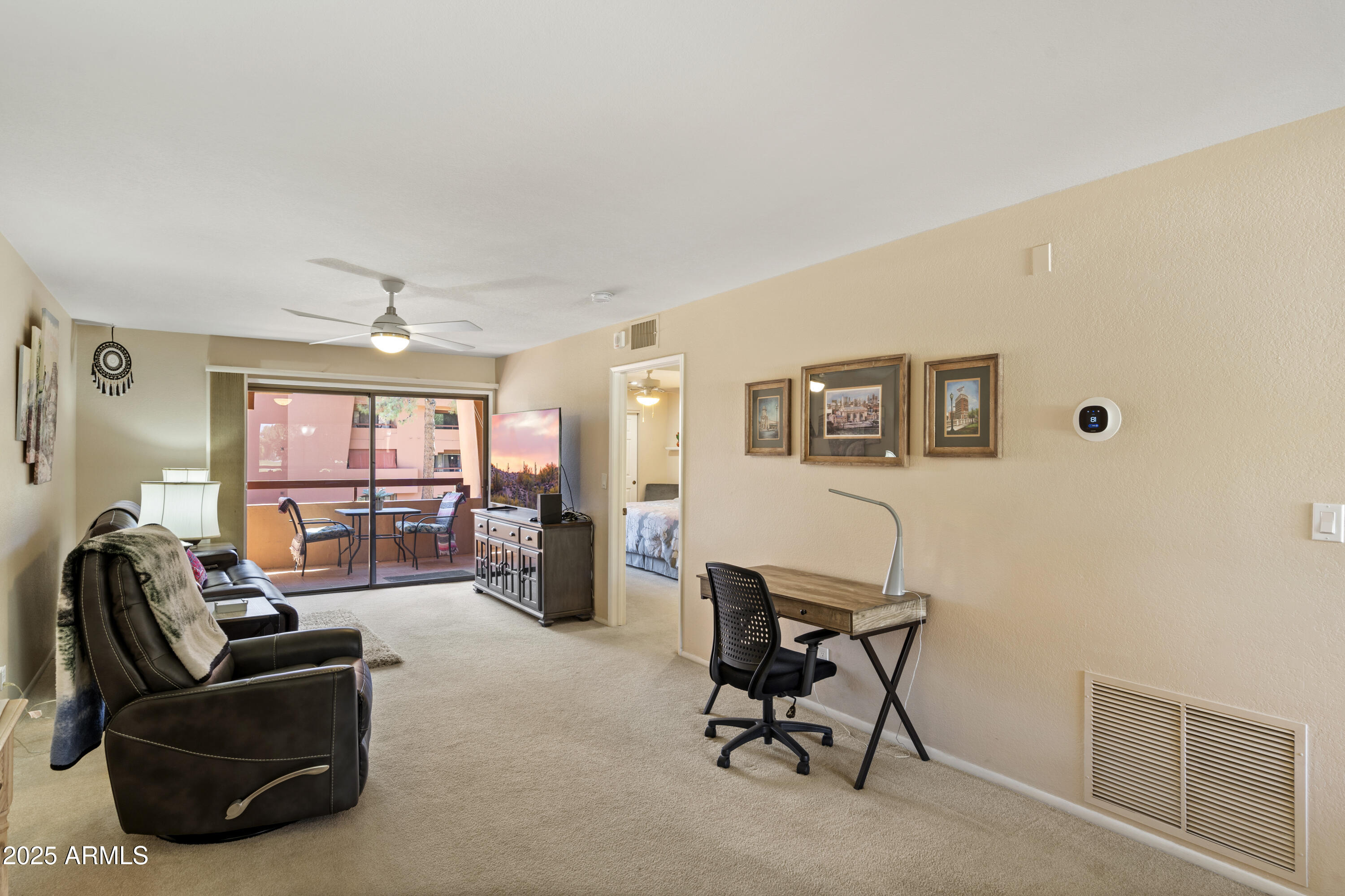 4303 East Cactus Road, Unit 222 Phoenix, AZ 85032 - Photo 9 of 38 a livingroom with workspace window and a couch