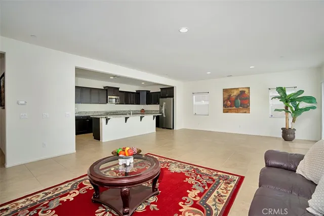 a living room with kitchen island furniture and a potted plant