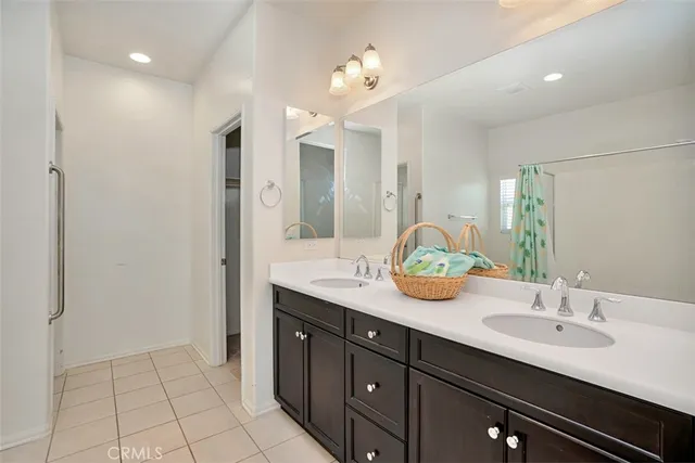 a bathroom with a sink double vanity and a mirror