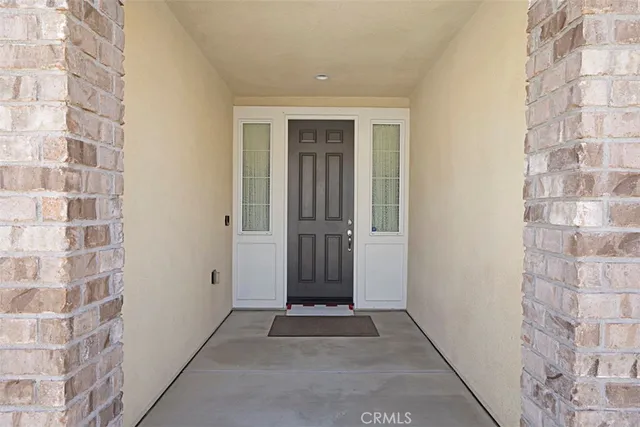 a view of a hallway with brick walls