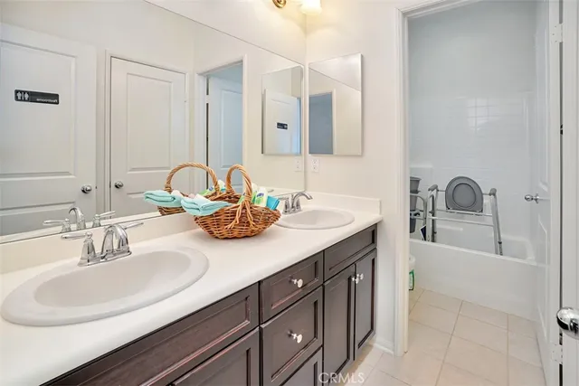 a bathroom with a double vanity sink and a mirror