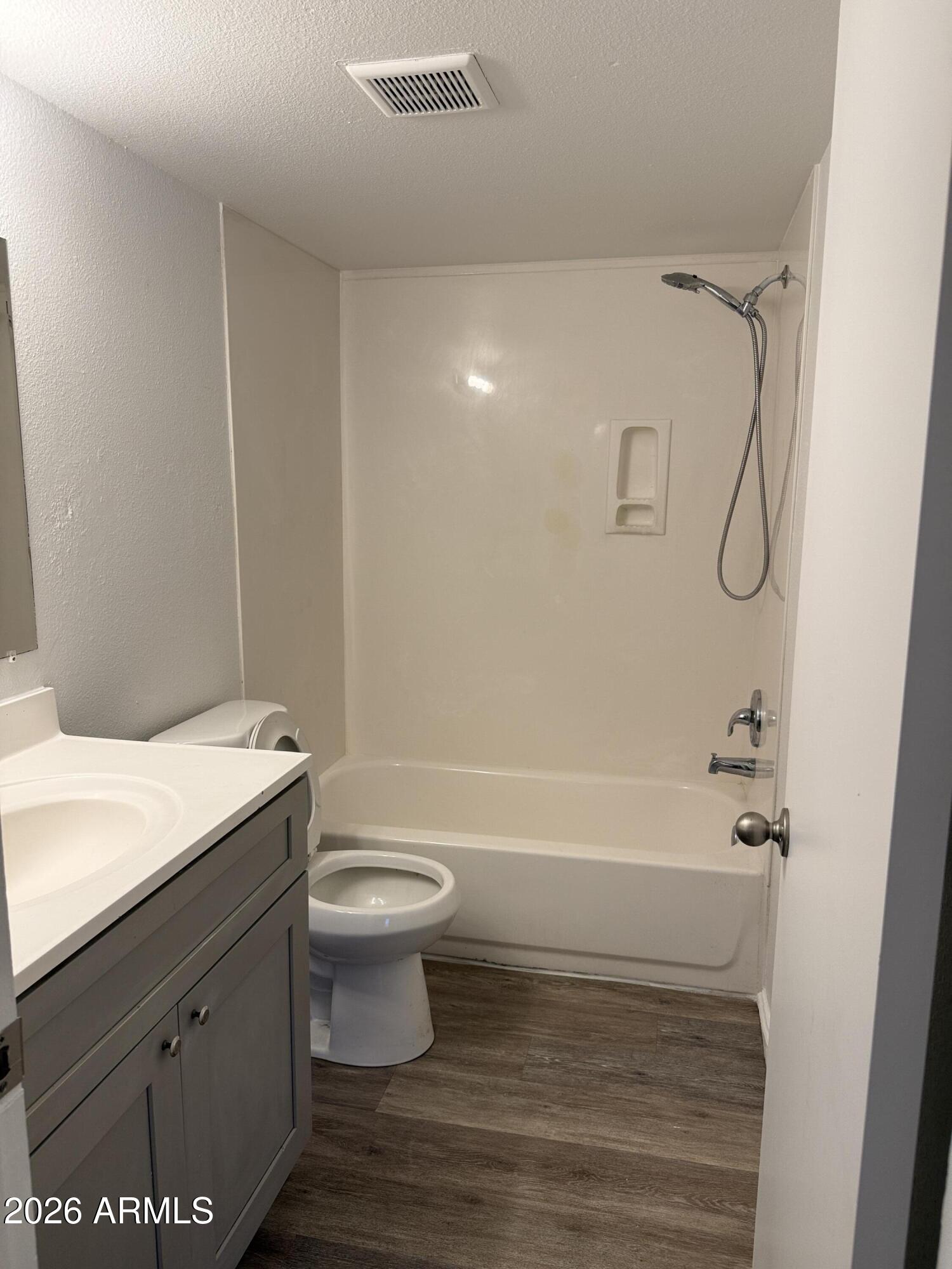 860 East Brown Road, Unit 53 Mesa, AZ 85203 - Photo 6 of 14 a bathroom with a sink a toilet and shower