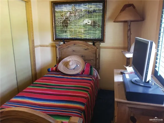 a room with a bed and a flat screen tv