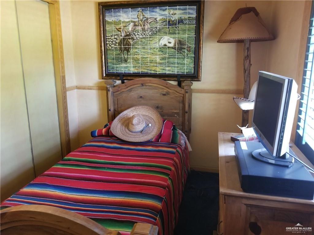 0 Fm 755 Highway Rio Grande City, TX 78582 - Photo 11 of 19 a room with a bed and a flat screen tv