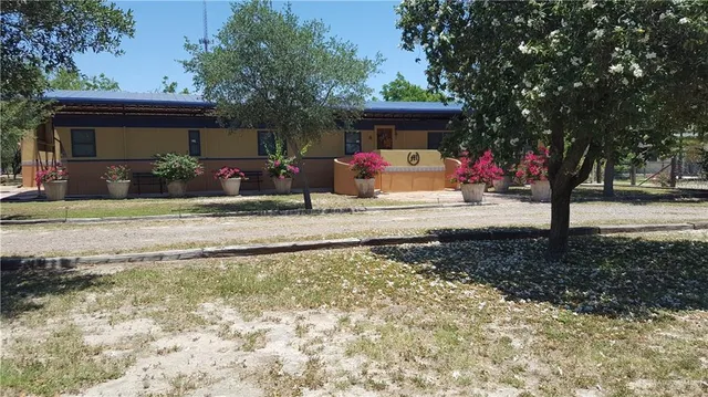 a view of a house with backyard porch and sitting area