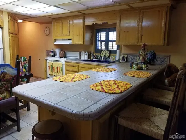 a dining table with chairs and window