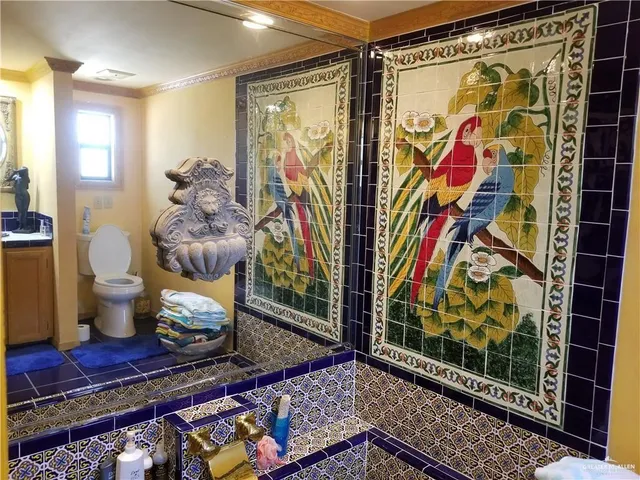 a front view of a house with garden and furniture