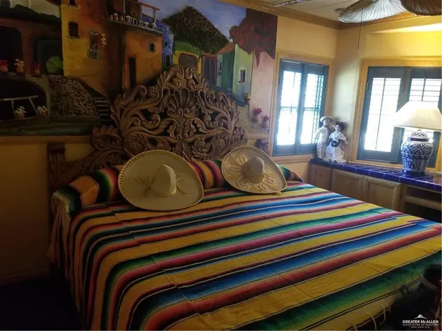 a bedroom with a bed and a mirror